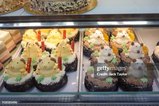 Dog-themed cakes sit on display in a bakery in Chinatown ahead of Chinese New Year tomorrow on February 15, 2018 in London, England. Chinese New...