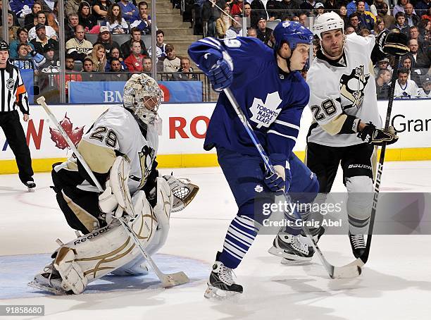 John Mitchell of the Toronto Maple Leafs battles with Eric Godard of the Pittsburgh Penguins in front of goalie Marc-Andre Fleury during game action...