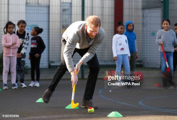Prince Harry shows off his hockey skills as he visits a Fit and Fed February school holiday activity programme at the Roundwood Youth Centre on...