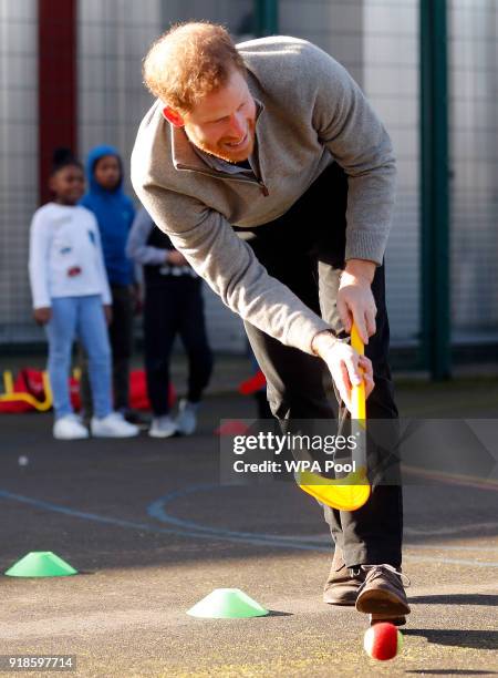 Prince Harry shows off his hockey skills as he visits a Fit and Fed February school holiday activity programme at the Roundwood Youth Centre on...