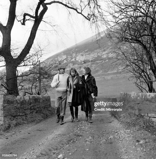 Actor John Mills, wife Mary Hayley Bell and their daughter Hayley Mills pictured out in the sun at Downham, Lancashire, studying the script of the...