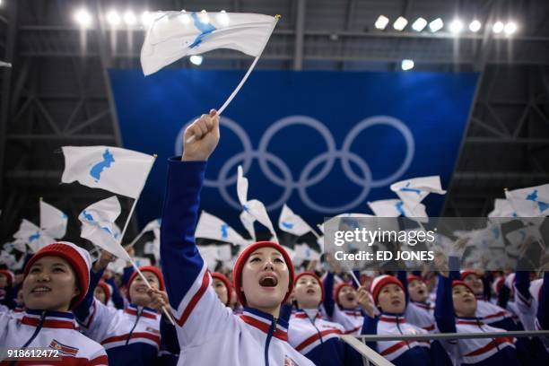 North Korean cheerleaders wave Unified Korea flags during the men's preliminary round ice hockey match between South Korea and Czech Republic during...