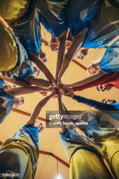 basketball team unity - sports team high five stock pictures, royalty-free photos & images