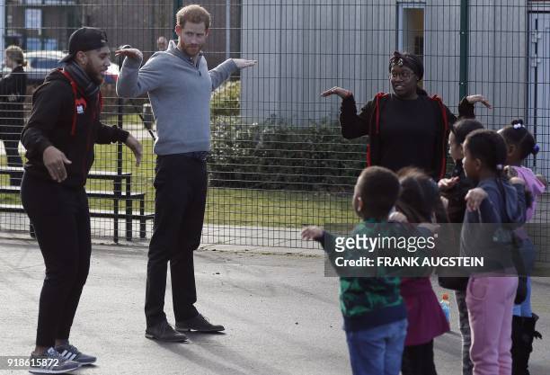Britain's Prince Harry interacts with children during his visit to Streetgames' Fit and Fed February school holiday activity programme at the...