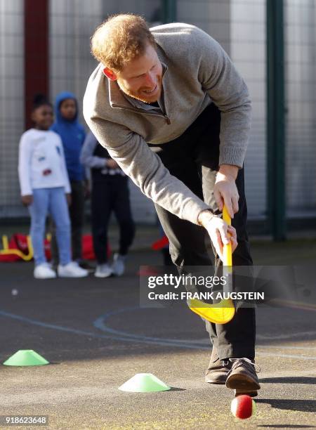 Britain's Prince Harry plays hockey with children during his visit to Streetgames' Fit and Fed February school holiday activity programme at the...