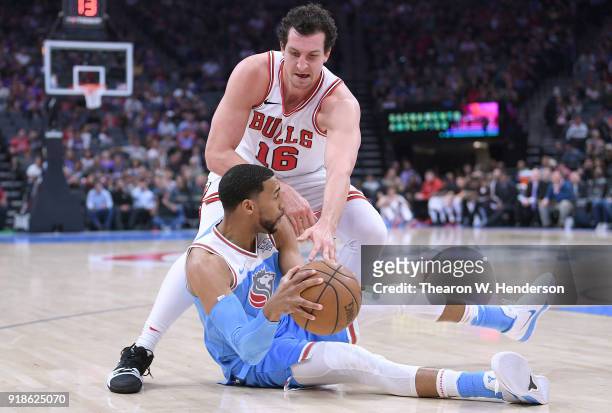 Garrett Temple of the Sacramento Kings falls to the floor fighting for the ball with Paul Zipser of the Chicago Bulls during an NBA basketball game...