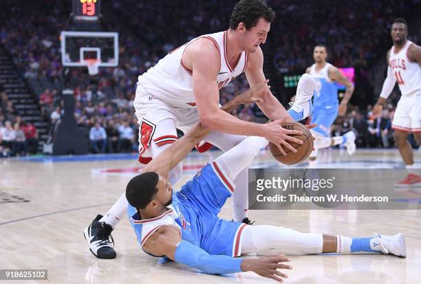Garrett Temple of the Sacramento Kings falls to the floor fighting for the ball with Paul Zipser of the Chicago Bulls during an NBA basketball game...