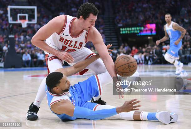 Garrett Temple of the Sacramento Kings falls to the floor fighting for the ball with Paul Zipser of the Chicago Bulls during an NBA basketball game...