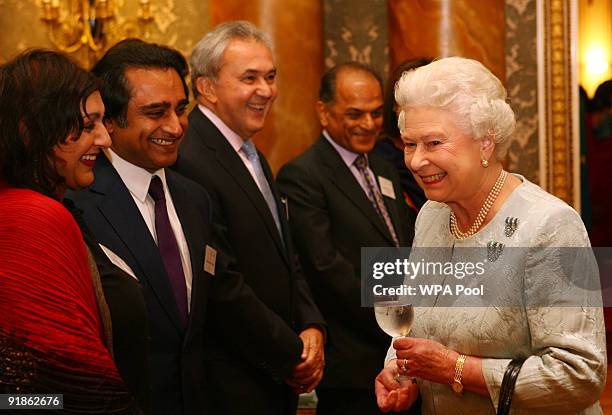 Queen Elizabeth II meets comedian/actors Sanjeev Bhaskar and Meera Syal after watching a performance by Nutkhut, a London-based British-Asian dance...