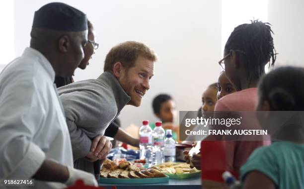 Britain's Prince Harry serves pasta during his visit to Streetgames' Fit and Fed February school holiday activity programme at the Roundwood Youth...