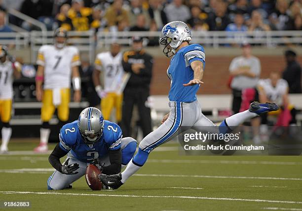 Jason Hanson of the Detroit Lions kicks a field goal while Nick Harris holds the football against the Pittsburgh Steelers at Ford Field on October...