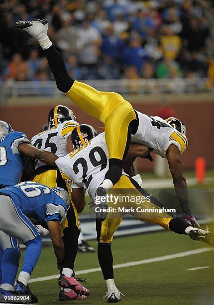 Ike Taylor of the Pittsburgh Steelers flys through the air while trying to make a tackle against the Detroit Lions at Ford Field on October 11, 2009...