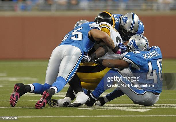 Rashard Mendenhall of the Pittsburgh Steelers is tackled by Larry Foote, Marquand Manuel and Julian Peterson of the Detroit Lions at Ford Field on...