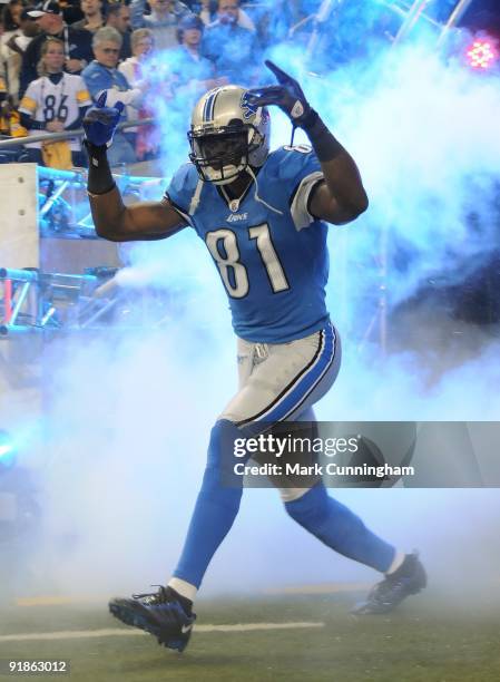 Calvin Johnson of the Detroit Lions points to the crowd during player introductions before the game against the Pittsburgh Steelers at Ford Field on...