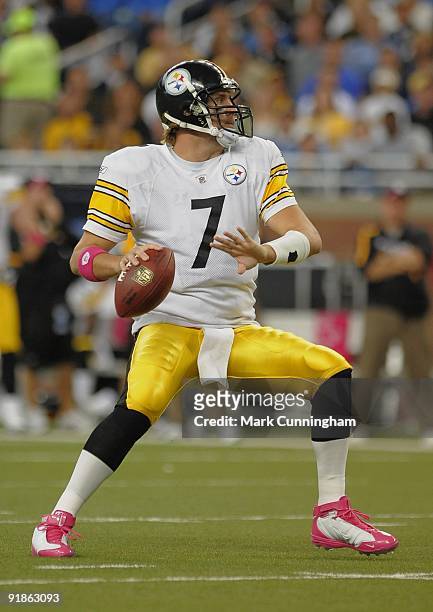 Ben Roethlisberger of the Pittsburgh Steelers looks to throw a pass while wearing pink wristbands and shoes to honor Breast Cancer Awareness Month...