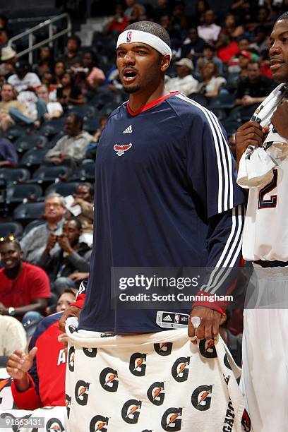 Josh Smith of the Atlanta Hawks looks on from the sideline during the preseason game against the New Orleans Hornets at Philips Arena on October 7,...