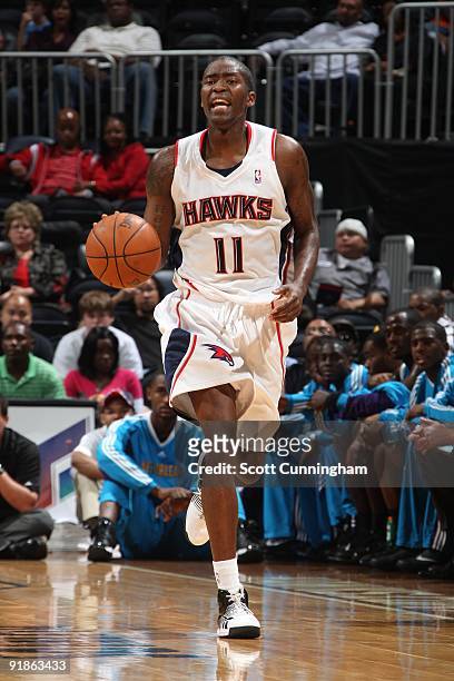 Jamal Crawford of the Atlanta Hawks moves the ball up court during the preseason game against the New Orleans Hornets at Philips Arena on October 7,...