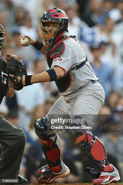 Yadier Molina of the St. Louis Cardinals looks to throw the ball to first base in Game Two of the NLDS during the 2009 MLB Playoffs against the Los...