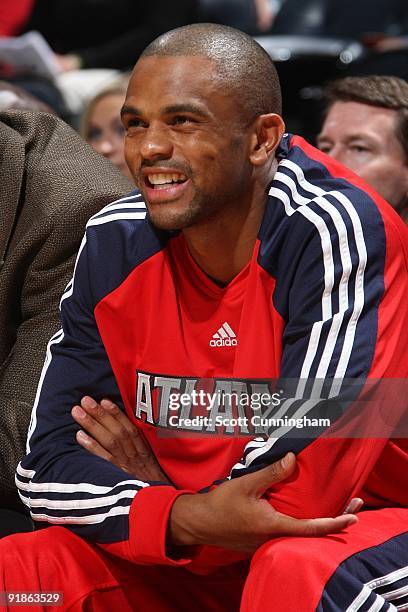 Juan Dixon of the Atlanta Hawks smiles from the bench during the preseason game against the New Orleans Hornets at Philips Arena on October 7, 2009...