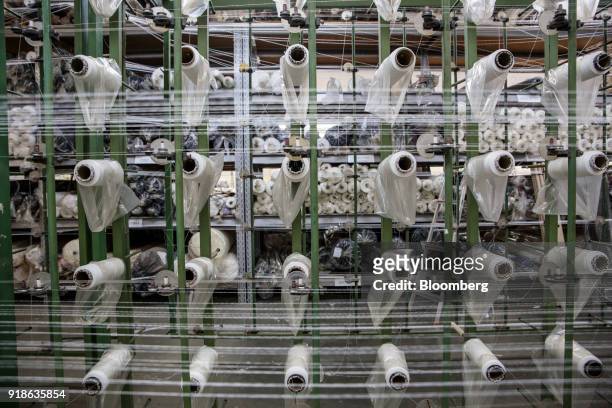 Rolls of thread pass through a loom at a textile factory in Nova Odessa, Sao Paulo state, Brazil, on Friday, Feb. 2, 2018. The Central Bank of Brazil...