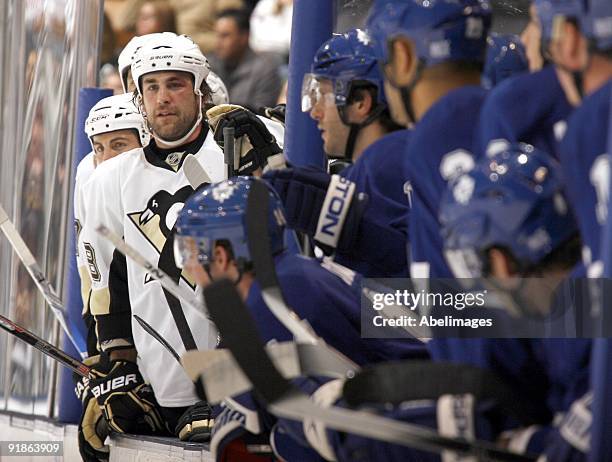Eric Godard of the Pittsburgh Penguins looks out from the bench against the Toronto Maple Leafs during a NHL game at the Air Canada Centre on October...