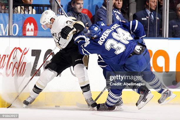 Jay Rosehill and Mikhail Grabovski of the Toronto Maple Leafs try and get the puck from Alex Goligoski of the Pittsburgh Penguins during a NHL game...