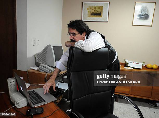 Toppled Honduran President Manuel Zelaya checks his personal laptop inside the Brazilian embassy in Tegucigalpa, on October 13, 2009. Representatives...