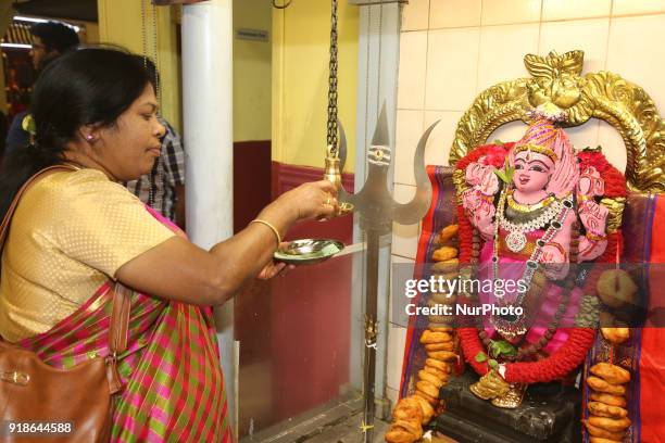 Tamil Hindu woman lights a lamp at the shrine of Lord Shiva during the Maha Shivratri festival at a Tamil Hindu temple in Ontario, Canada, on...