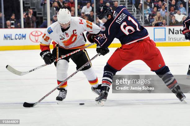Jarome Iginla of the Calgary Flames attempts to skate the puck past Rick Nash of the Columbus Blue Jackets on October 13, 2009 at Nationwide Arena in...