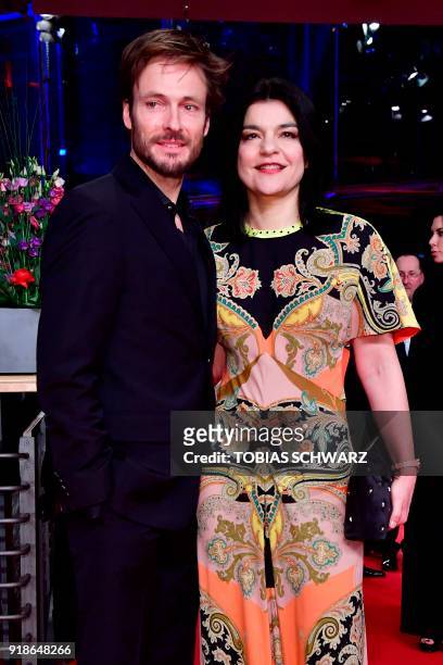German actress Jasmin Tabatabai and her partner Andreas Pietschmann pose on the red carpet upon their arrival at the Berlinale Palace for the opening...