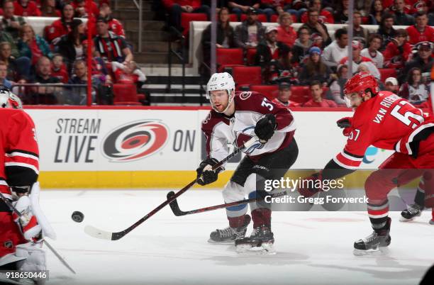 Compher of the Colorado Avalanche shoots the puck past the defense if Trevor van Riemsdyk during an NHL game on February 10, 2018 at PNC Arena in...