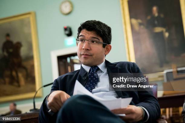 New York City Council member and chairman of the Committee on Immigration Carlos Menchaca goes over notes before the start of a committee hearing...
