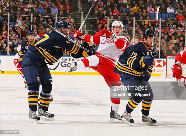 Tyler Myers and Tim Connolly of the Buffalo Sabres defend against Justin Abdelkader of the Detroit Red Wings during the second period on October 13,...