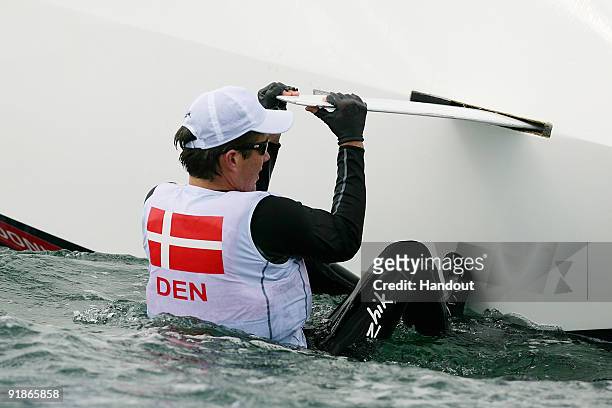 In this handout photo provided by Sydney 2009 World Masters Games, Crown Prince Frederik of Denmark holds onto the keel of his boat after he and his...