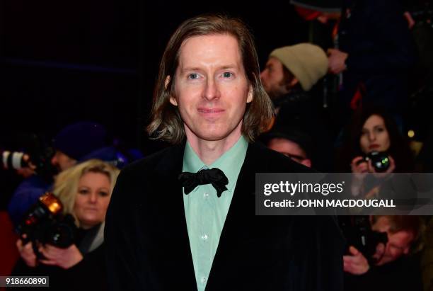 Director Wes Anderson poses on the red carpet upon arrival at the Berlinale Palace for the opening ceremony of the 68th Berlinale film festival with...