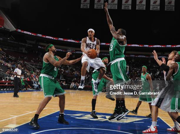 Courtney Lee of the New Jersey Nets shoots against Rasheed Wallace and Kendrick Perkins of the Boston Celtics during the pre-season game on October...