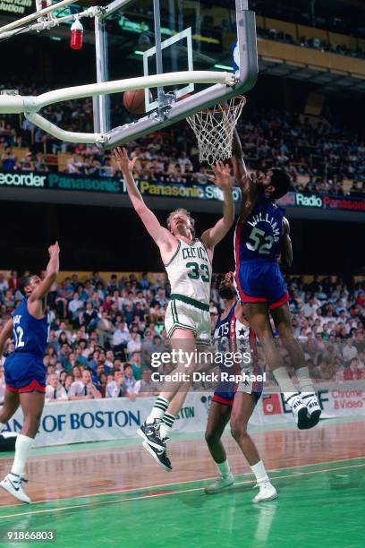 Larry Bird of the Boston Celtics shoots a layup against Buck Williams of the New Jersey Nets during a game played in 1986 at the Boston Garden in...