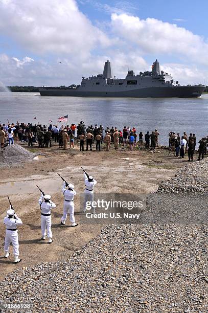 In this photo provided by the U.S. Navy, members of the Naval Air Station Joint Reserve Base New Orleans honor guard render honors to the amphibious...