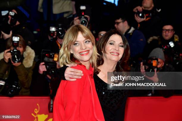 German actress Heike Makatsch and German actress Iris Berben pose on the red carpet upon their arrival at the Berlinale Palace for the opening...