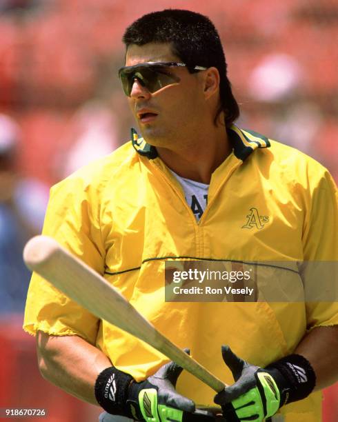 Jose Canseco of the Oakland Athletics looks on during an MLB game against the Milwaukee Brewers at County Stadium in Milwaukee, Wisconsin during the...