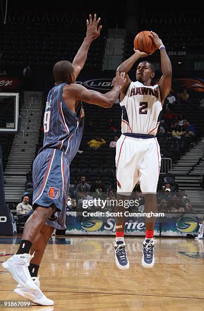 Joe Johnson of the Atlanta Hawks takes a jump shot against Raja Bell of the Charlotte Bobcats during the preseason game on October 12, 2009 at...