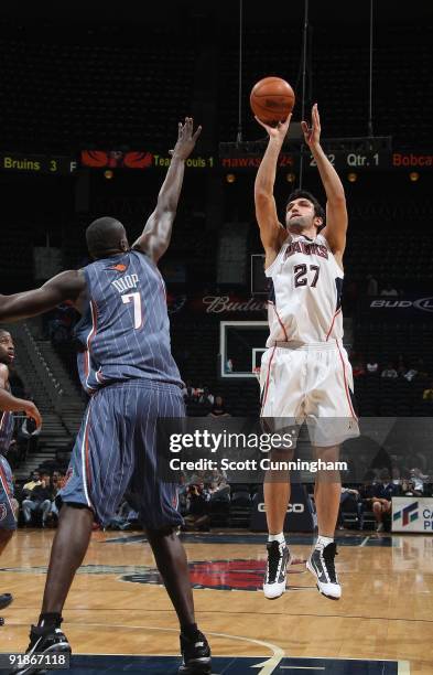 Zaza Pachulia of the Atlanta Hawks takes a jump shot against DeSagana Diop of the Charlotte Bobcats during the preseason game on October 12, 2009 at...