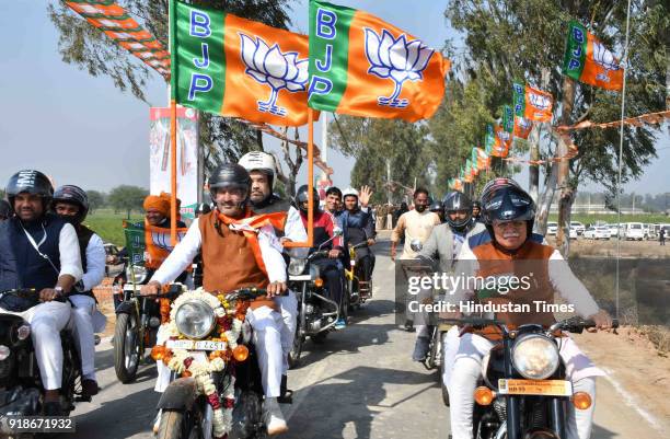 President Amit Shah riding pillion with BJP State President Subhash Barala on a motorcycle, on the way to venue of rally organised on February 15,...