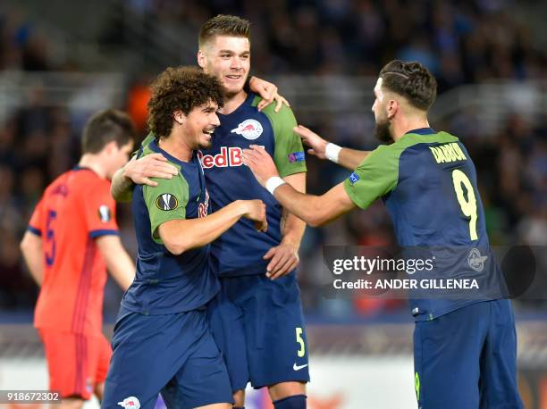 Salzburg's Croatian defender Duje Caleta-Car is congratulated by teammates Brazilian defender Andre Ramalho and Israeli forward Munas Dabbur during...