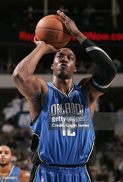 Dwight Howard of the Orlando Magic shoots a free throw during the preseason game against the Dallas Mavericks at the American Airlines Center on...
