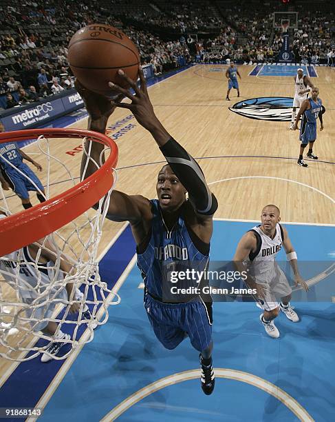 Dwight Howard of the Orlando Magic lays up a shot against the Dallas Mavericks during the preseason game at the American Airlines Center on October...