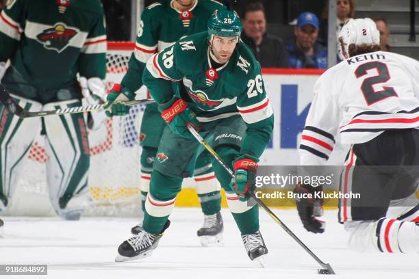 Daniel Winnik of the Minnesota Wild skates with the puck against the Chicago Blackhawks during the game at the Xcel Energy Center on February 10,...