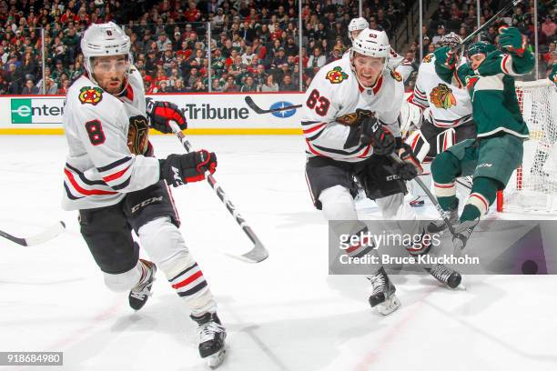 Nick Schmaltz and Carl Dahlstrom of the Chicago Blackhawks skate to the puck against Zach Parise of the Minnesota Wild during the game at the Xcel...