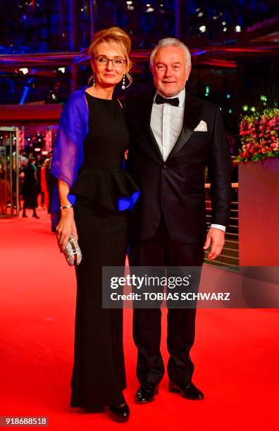 Vice-Chairman Wolfgang Kubicki and his wife Annette Marberth-Kubicki pose on the red carpet for the opening ceremony of the 68th Berlinale film...