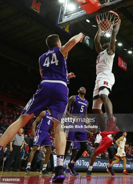 Mamadou Doucoure of the Rutgers Scarlet Knights dunks as Gavin Skelly of the Northwestern Wildcats defends during the second half of a game at...